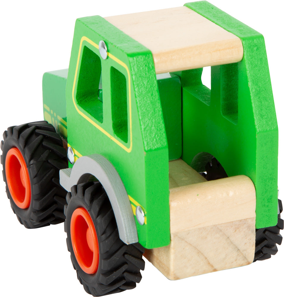 Schöner Holz-Traktor in grün mit gummierten Rrifen und fröhlichem Gesicht