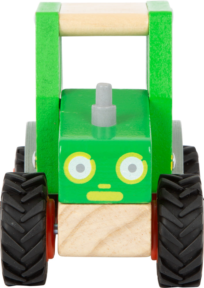 Schöner Holz-Traktor in grün mit gummierten Rrifen und fröhlichem Gesicht