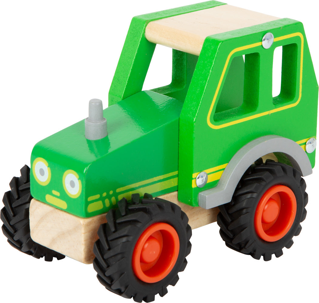 Schöner Holz-Traktor in grün mit gummierten Rrifen und fröhlichem Gesicht