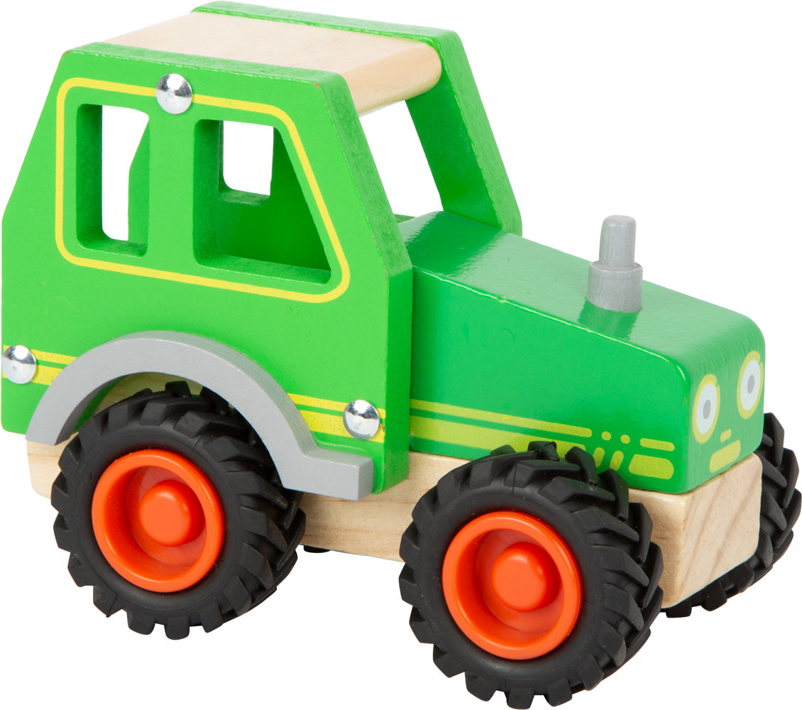 Schöner Holz-Traktor in grün mit gummierten Rrifen und fröhlichem Gesicht